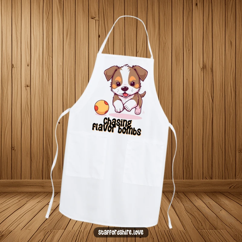 Funny, adorable Staffordshire puppy chasing a bouncy ball on a kitchen apron. Great funny gift for chefs.