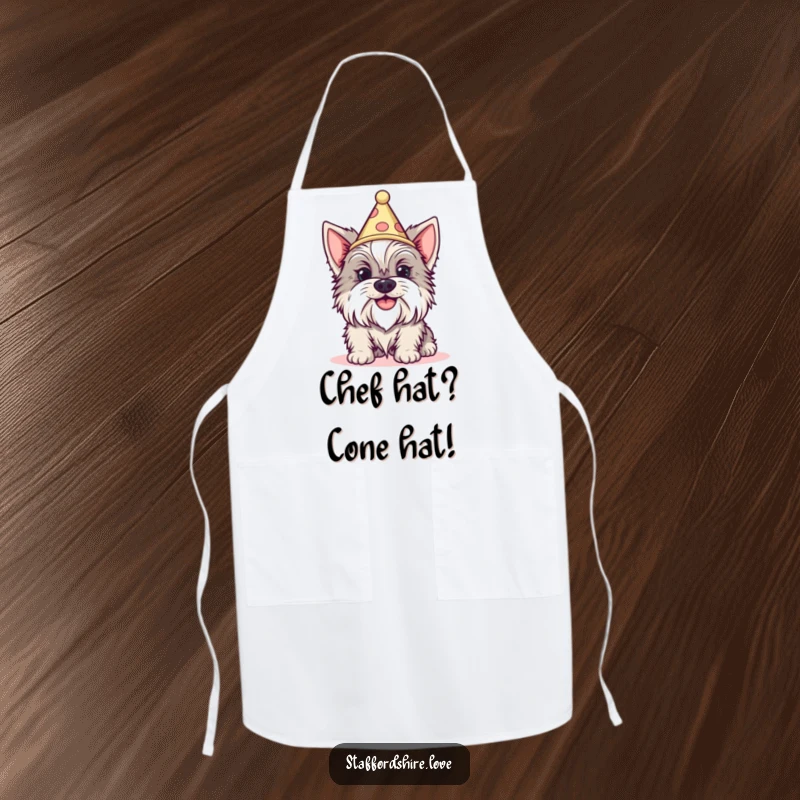 Funny Staffordshire dog with a silly grin wearing a tiny cone hat on a kitchen apron. Great gift.