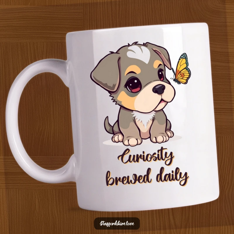 Funny Staffordshire pup with one ear flopped over, looking curiously at a fluttering butterfly on a ceramic mug.