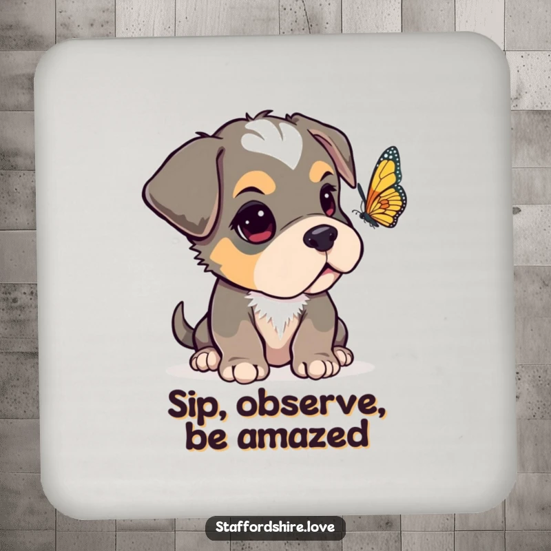 Funny Staffordshire pup with one ear flopped over, looking curiously at a fluttering butterfly on a set of protective drink coasters.