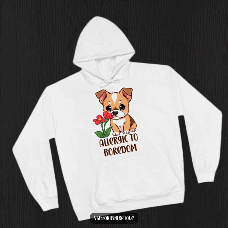 Funny Staffordshire dog hoodie depicting a curious dog with wide eyes, engrossed in sniffing a vibrant red flower, a symbol of gentle discovery.