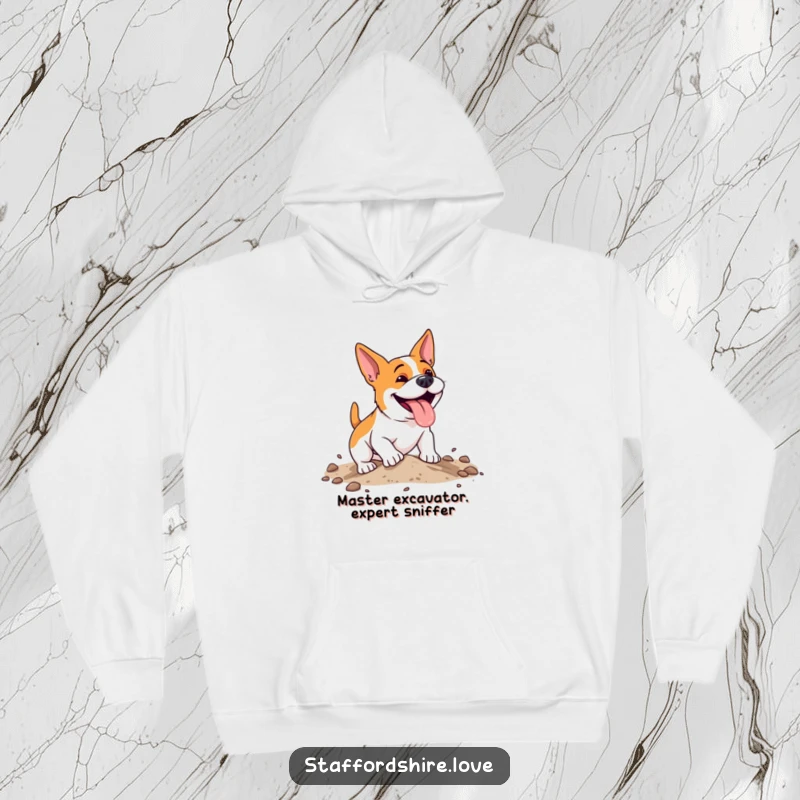 Funny, energetic Staffordshire dog with a happy pant, digging enthusiastically in soft earth on a warm, cozy hoodie.