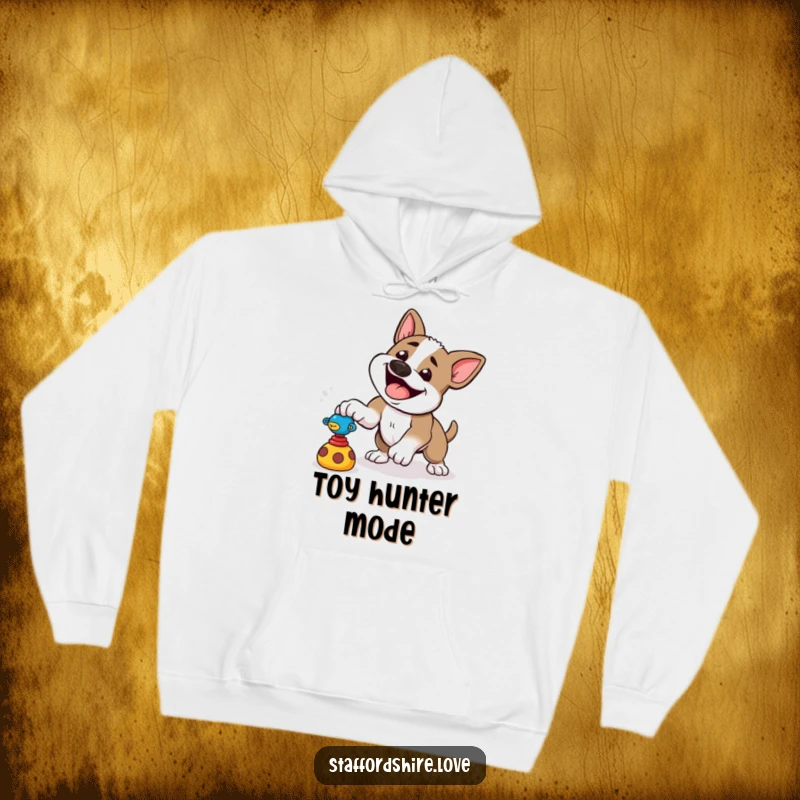 Funny hoodie featuring a happy Staffordshire dog playfully pouncing at a toy, perfect for energetic moments.