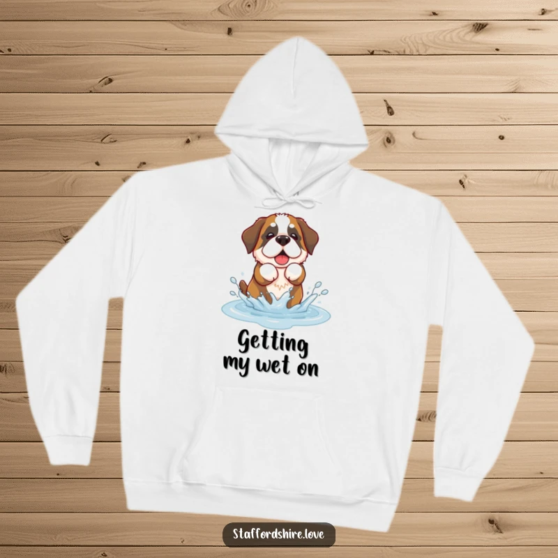 Funny hoodie with a kawaii Saint Bernard dog playfully splashing in a puddle, warm and adorable.