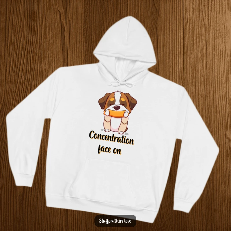 Funny hoodie featuring a Saint Bernard balancing a squeaky toy on its snout, perfect for cozying up with a smile.