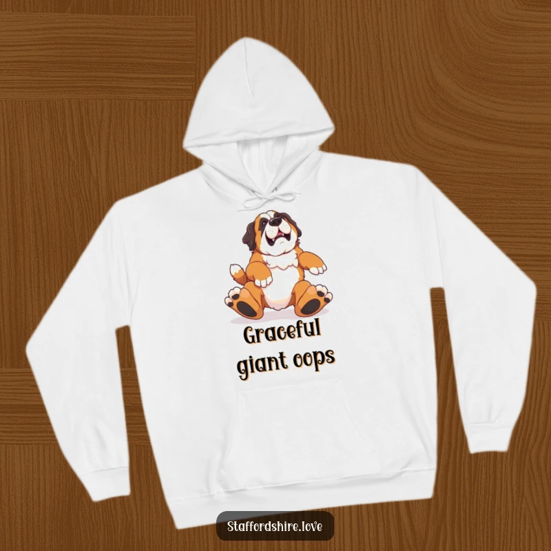 Funny hoodie featuring a Saint Bernard comically stumbling over its feet, perfect for cozying up with a laugh.