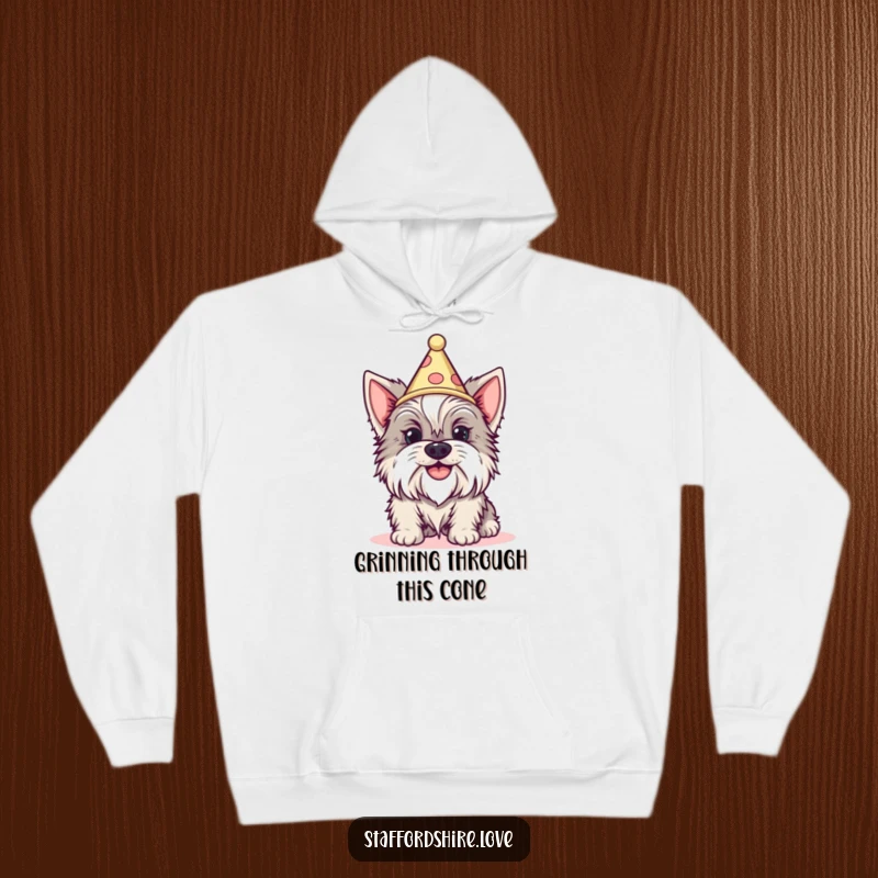 Funny Staffordshire dog with a silly grin wearing a tiny cone hat on a cozy hoodie. Great gift.