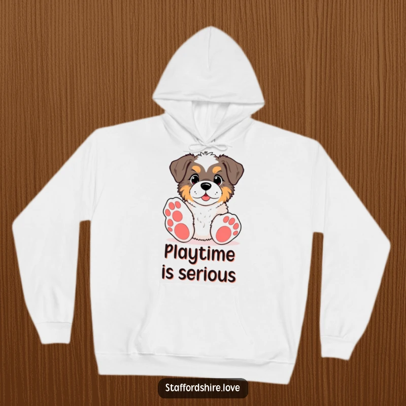 Funny kawaii Staffordshire hoodie, showing a pup with big paws reaching for a toy, designed for warm, humorous, and playful wear.
