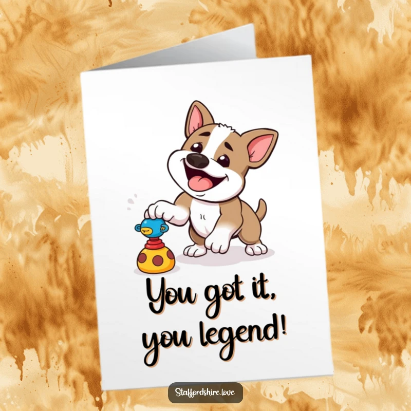 Funny free printable congratulations card: a happy Staffordshire dog is captured mid-pounce towards a toy.