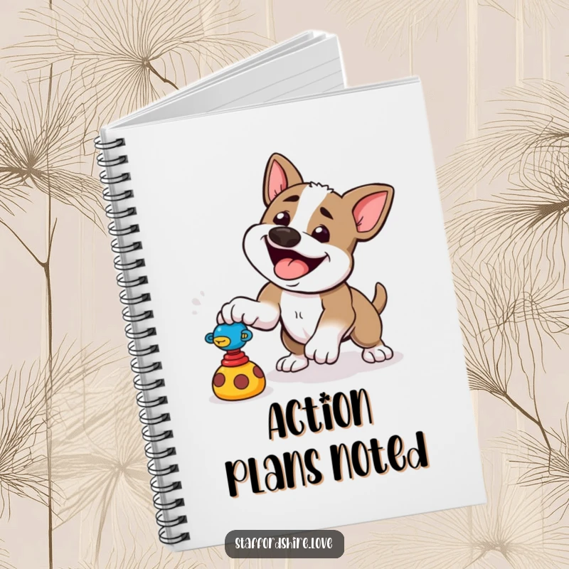 Funny notebook with a happy Staffordshire dog playfully pouncing at a toy, encouraging energetic writing.