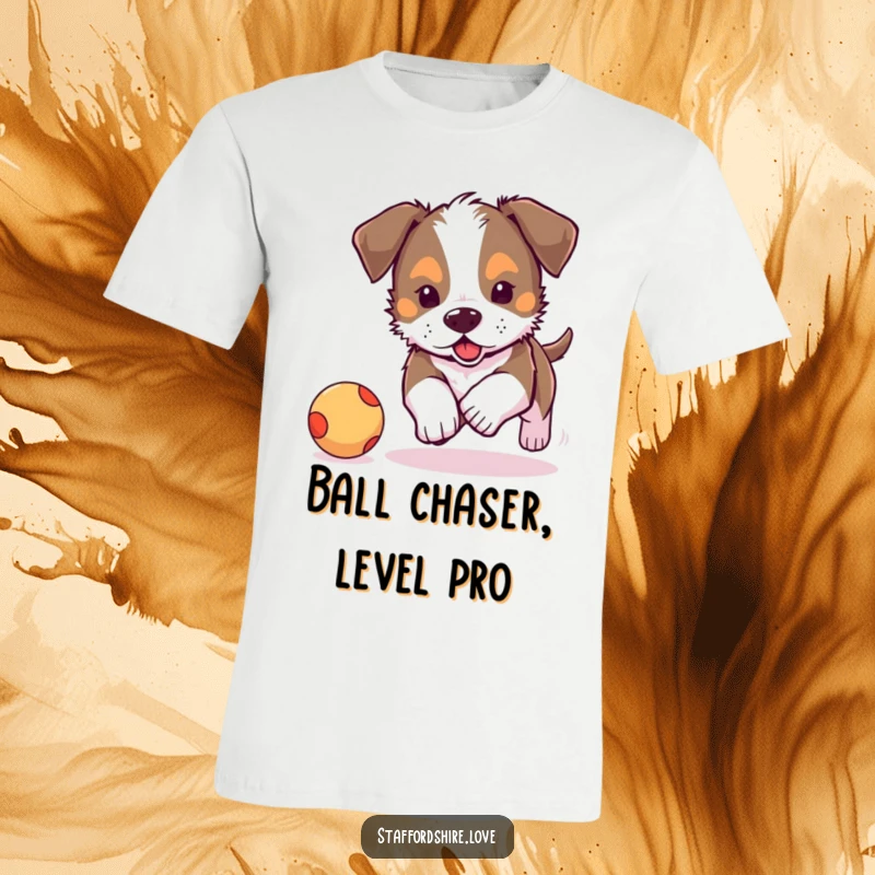 Funny, adorable Staffordshire puppy energetically chasing a bouncy ball on a t-shirt. Great gift for dog owners.
