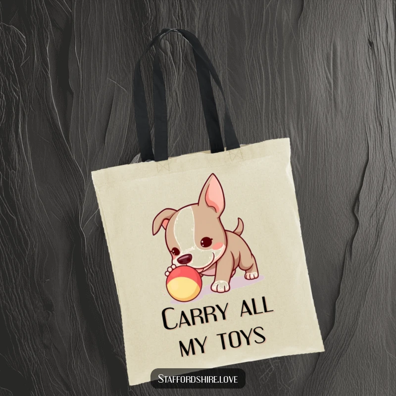Funny Kawaii Staffordshire Bull Terrier puppy tote bag, determinedly pursuing a squeaky toy, showcasing its playful and energetic nature.